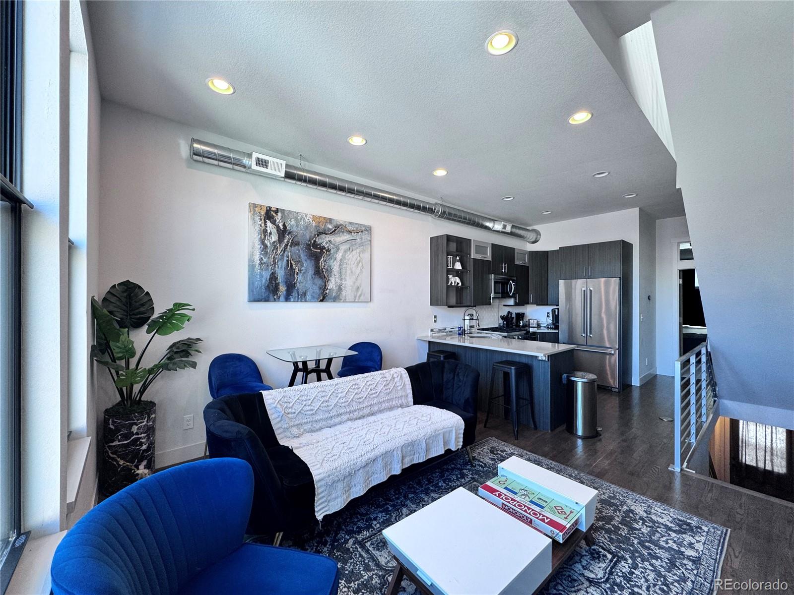 931 33rd Street Denver, CO 80205 - Photo 8 of 16 a living room with furniture and a dining area