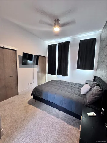 a bedroom with a large bed and a couch