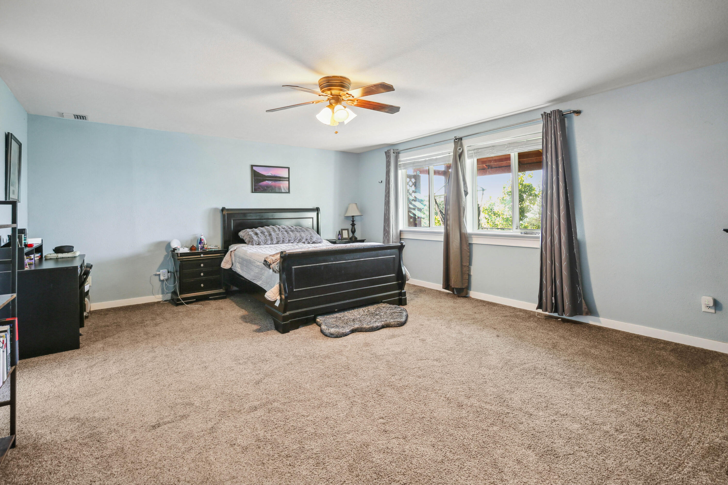 448 Wren Ridge Drive Eagle Point, OR 97524 - Photo 16 of 45 a bedroom with a bed and a chandelier