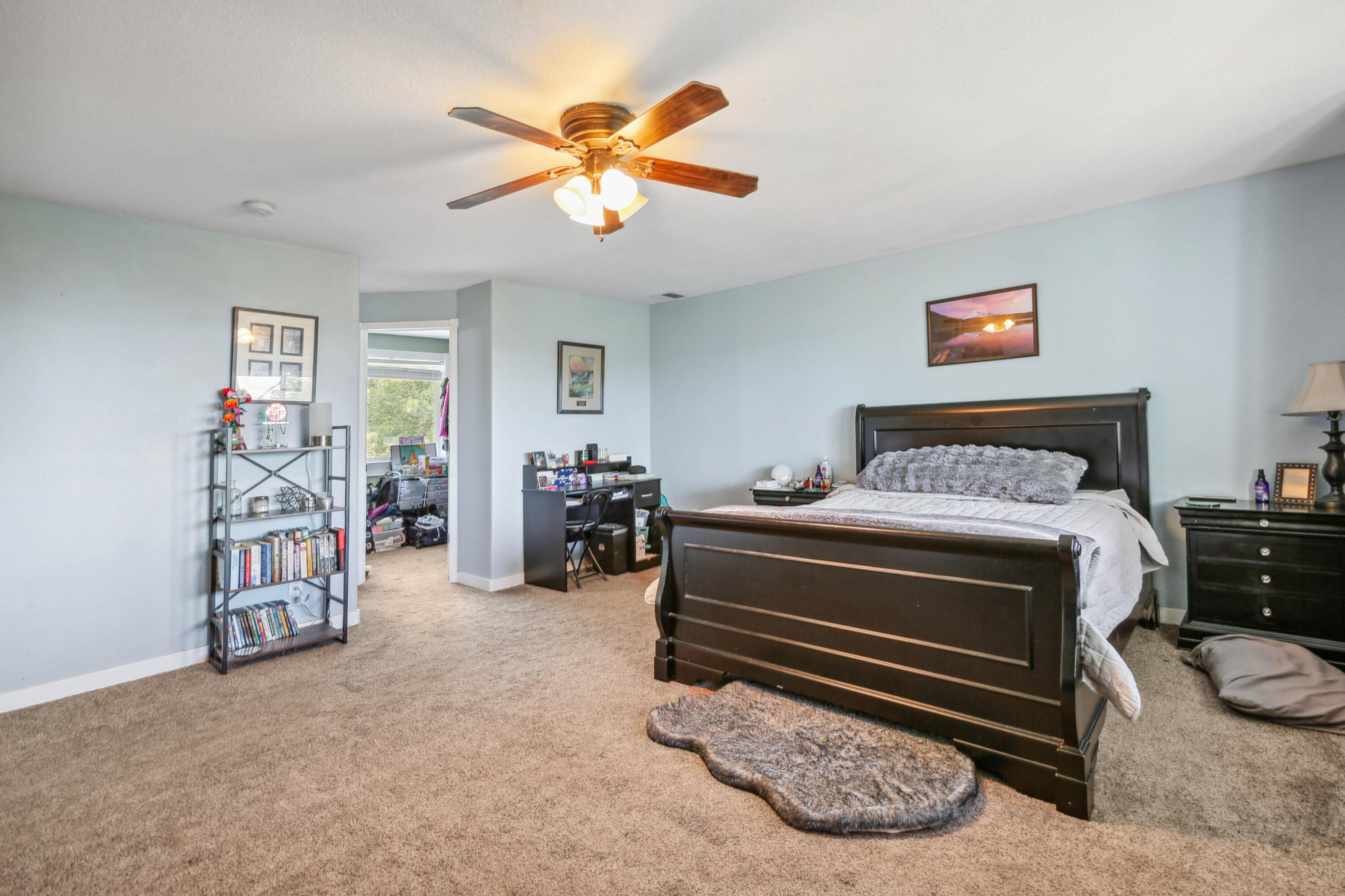 448 Wren Ridge Drive Eagle Point, OR 97524 - Photo 17 of 45 a bedroom with a bed and a chandelier