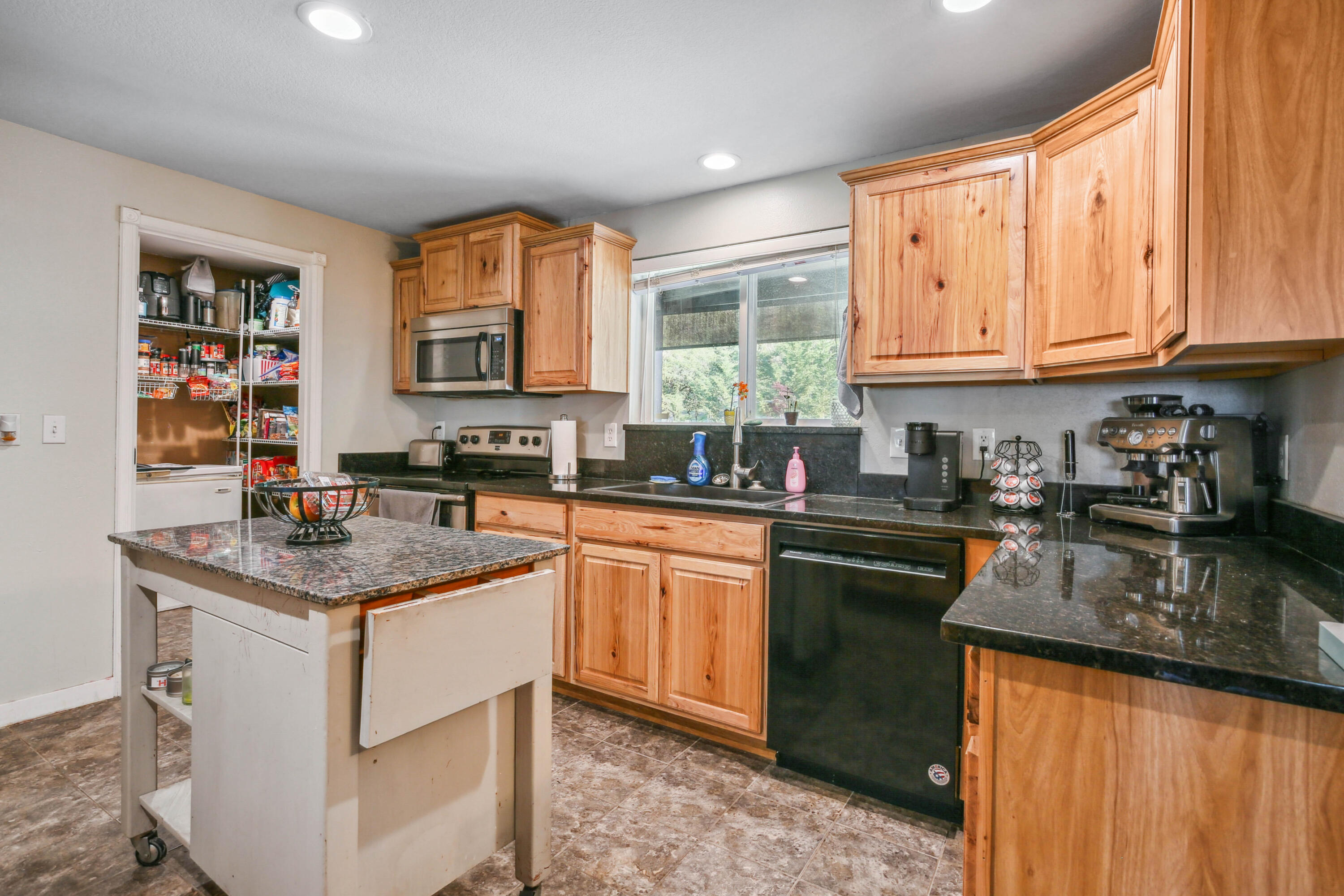 448 Wren Ridge Drive Eagle Point, OR 97524 - Photo 6 of 45 a kitchen with stainless steel appliances granite countertop a stove a sink dishwasher and cabinets with wooden floor