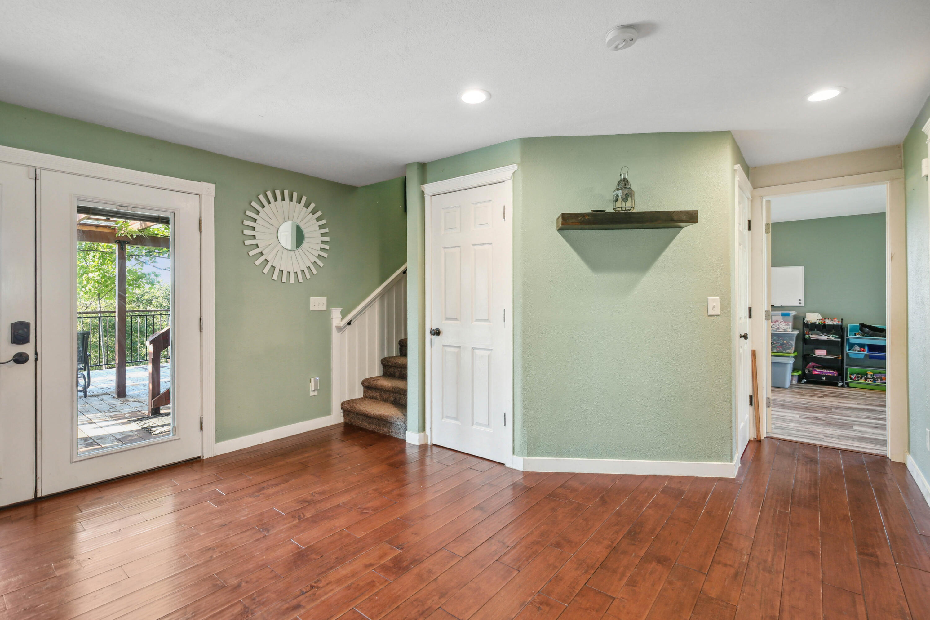 448 Wren Ridge Drive Eagle Point, OR 97524 - Photo 9 of 45 an empty room with wooden floor and a ceiling fan
