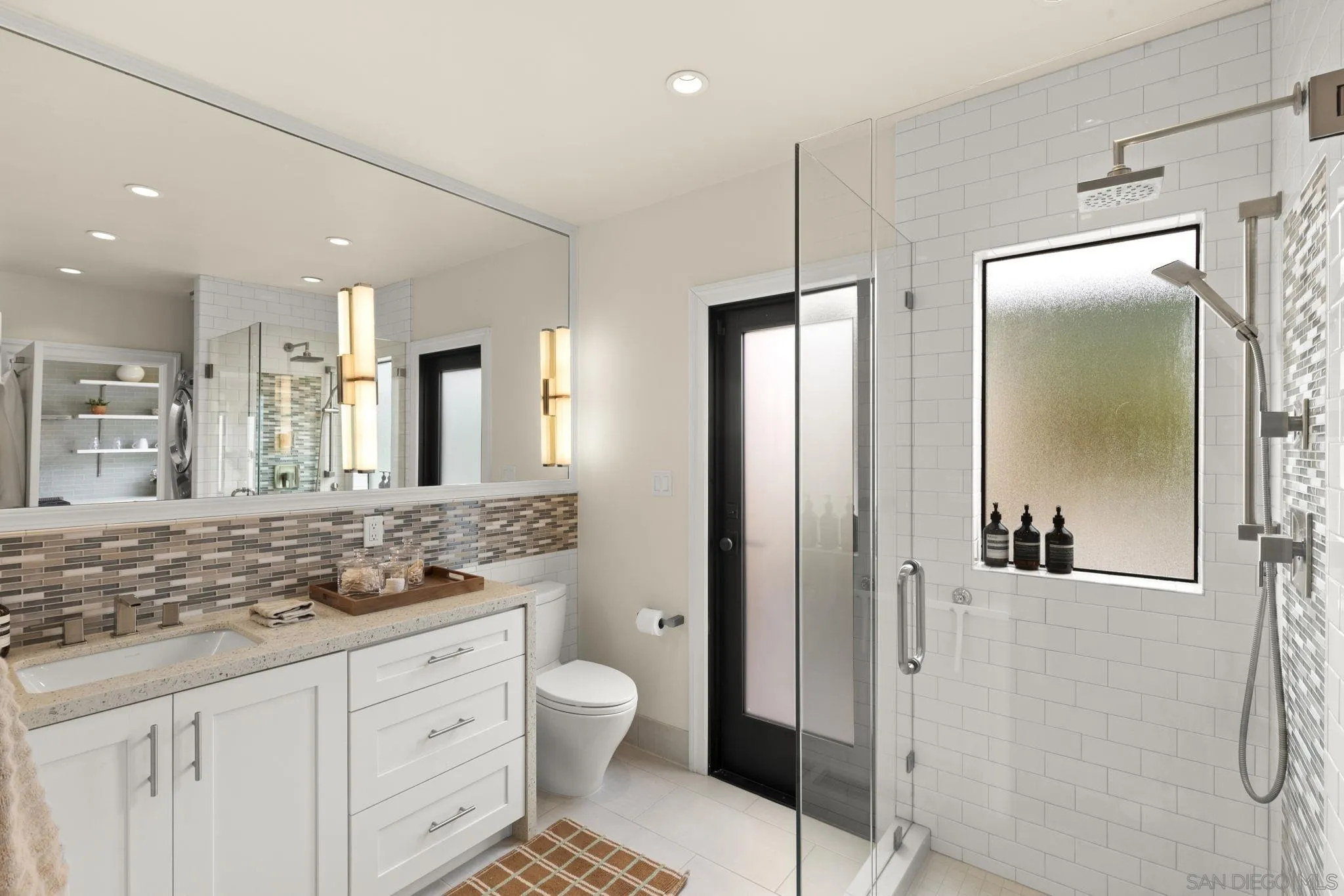 321 Fern Glen La Jolla, CA 92037 - Photo 15 of 46 a bathroom with a granite countertop sink mirror vanity and toilet