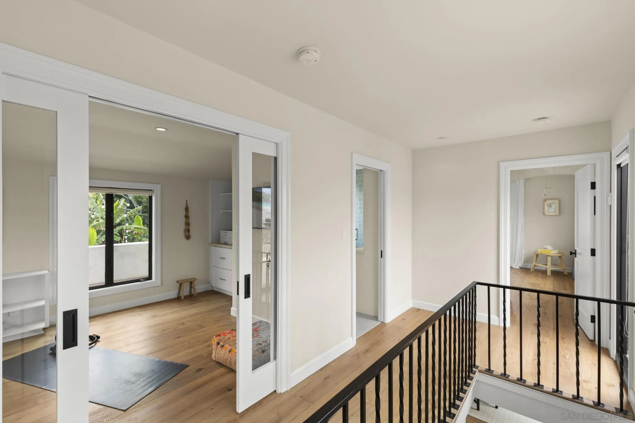 321 Fern Glen La Jolla, CA 92037 - Photo 17 of 46 a view of a hallway with wooden floor and dining room