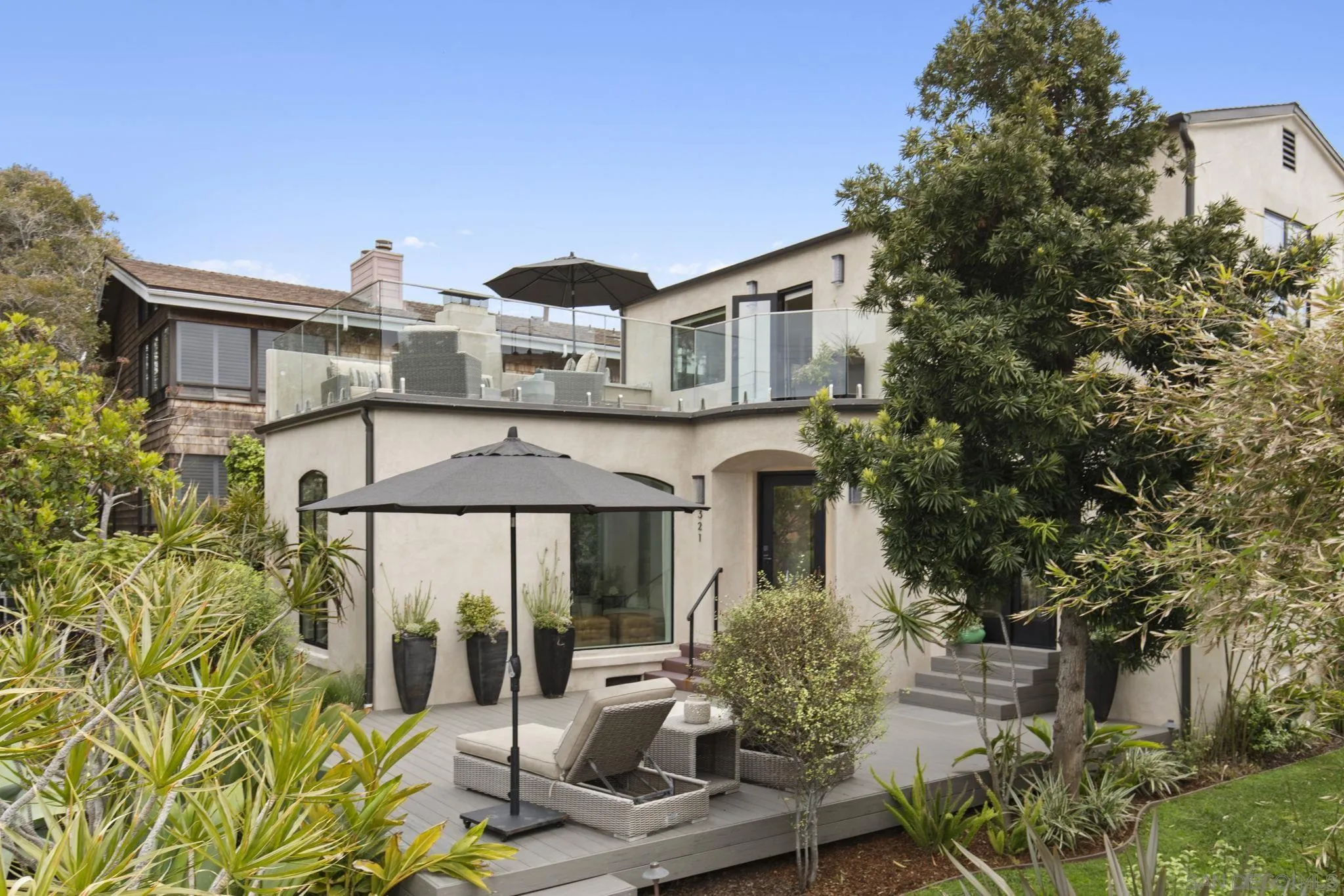 321 Fern Glen La Jolla, CA 92037 - Photo 2 of 46 a front view of a house with garden