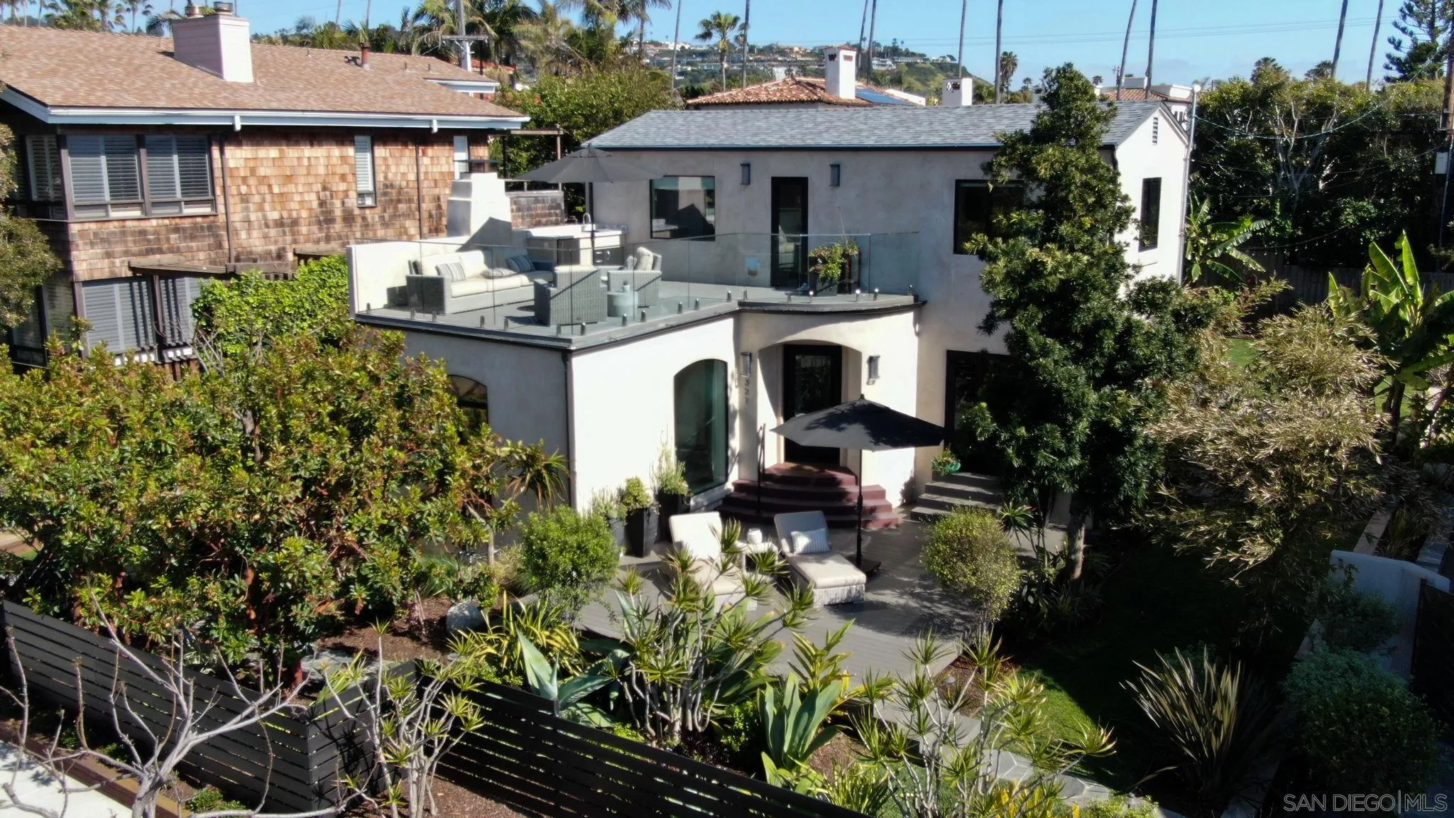 321 Fern Glen La Jolla, CA 92037 - Photo 25 of 46 a patio with sofas fire pit table and chairs