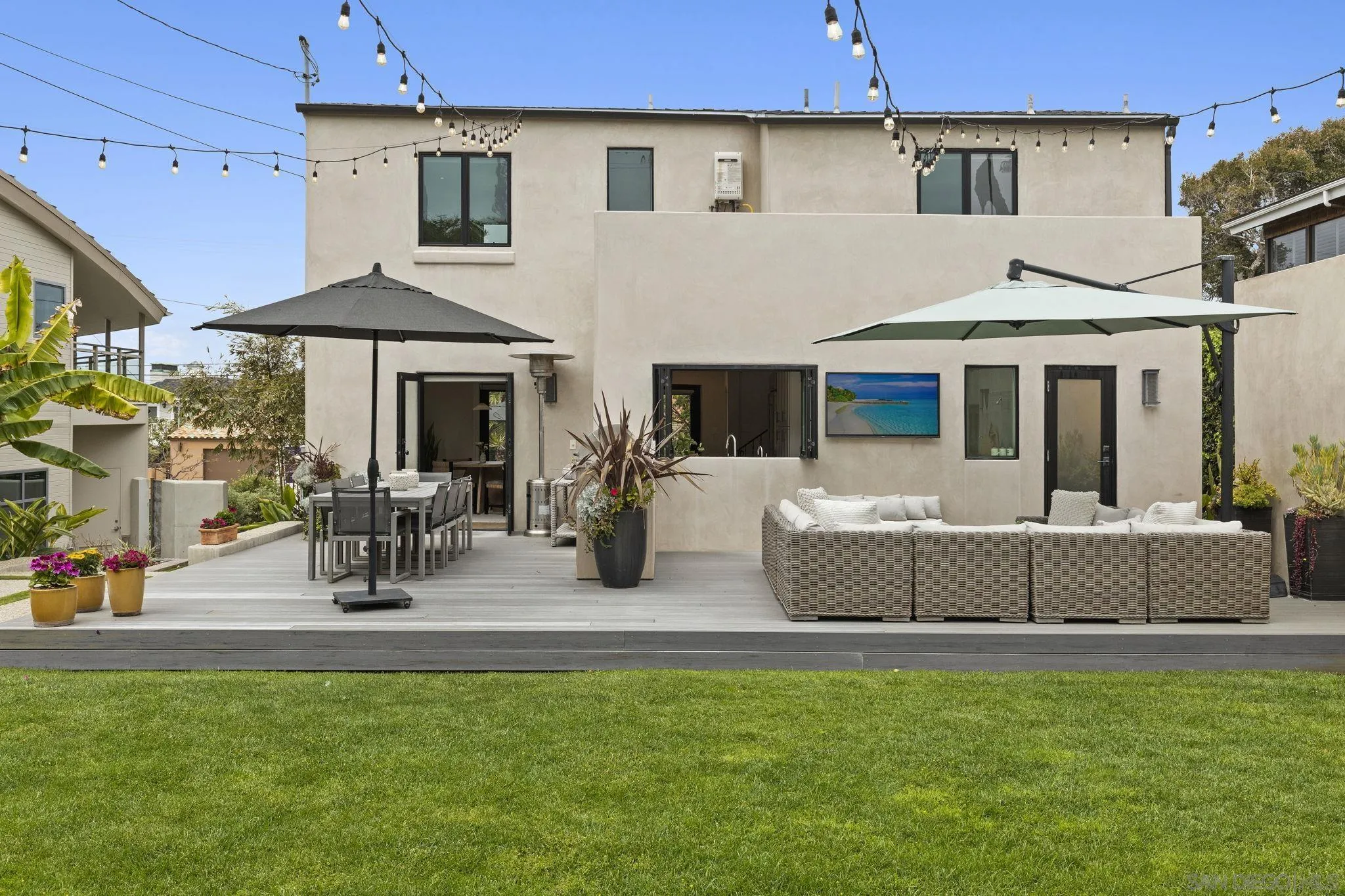 321 Fern Glen La Jolla, CA 92037 - Photo 26 of 46 a view of a patio with table and chairs under an umbrella