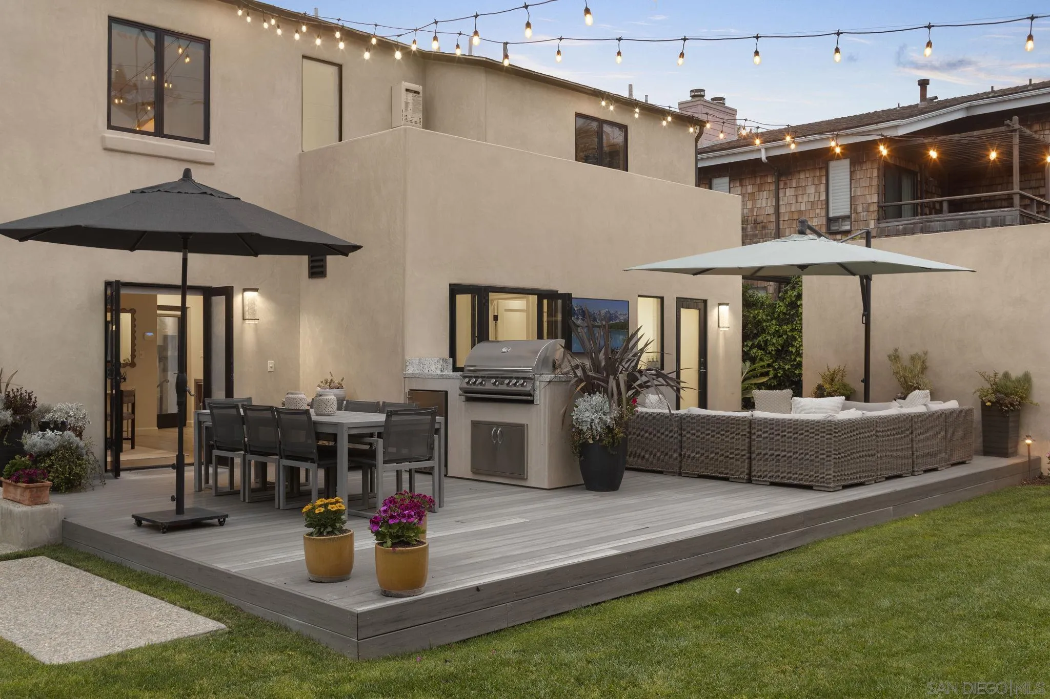 321 Fern Glen La Jolla, CA 92037 - Photo 32 of 46 a view of a patio with dining table and chairs under an umbrella