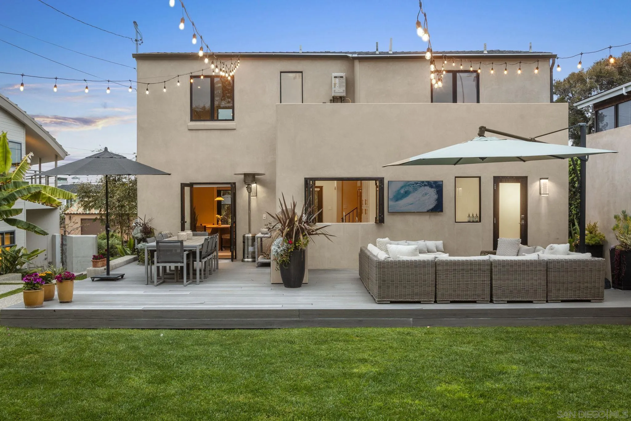 321 Fern Glen La Jolla, CA 92037 - Photo 34 of 46 a view of a patio with table and chairs potted plants and a floor to ceiling window