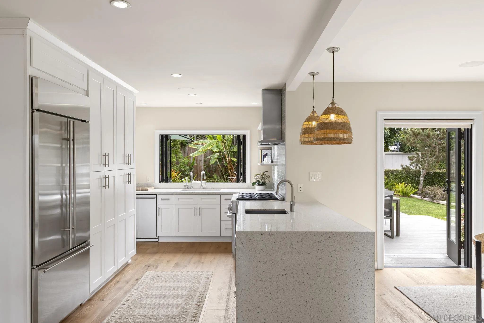 321 Fern Glen La Jolla, CA 92037 - Photo 10 of 46 a kitchen with kitchen island a counter top space a sink stainless steel appliances and cabinets