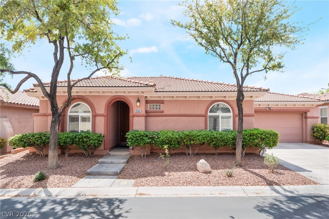 10481 Riverside Park Avenue Las Vegas, NV 89135 - Photo 2 of 51 Mediterranean / spanish house with a garage, stucco siding, driveway, and a tiled roof