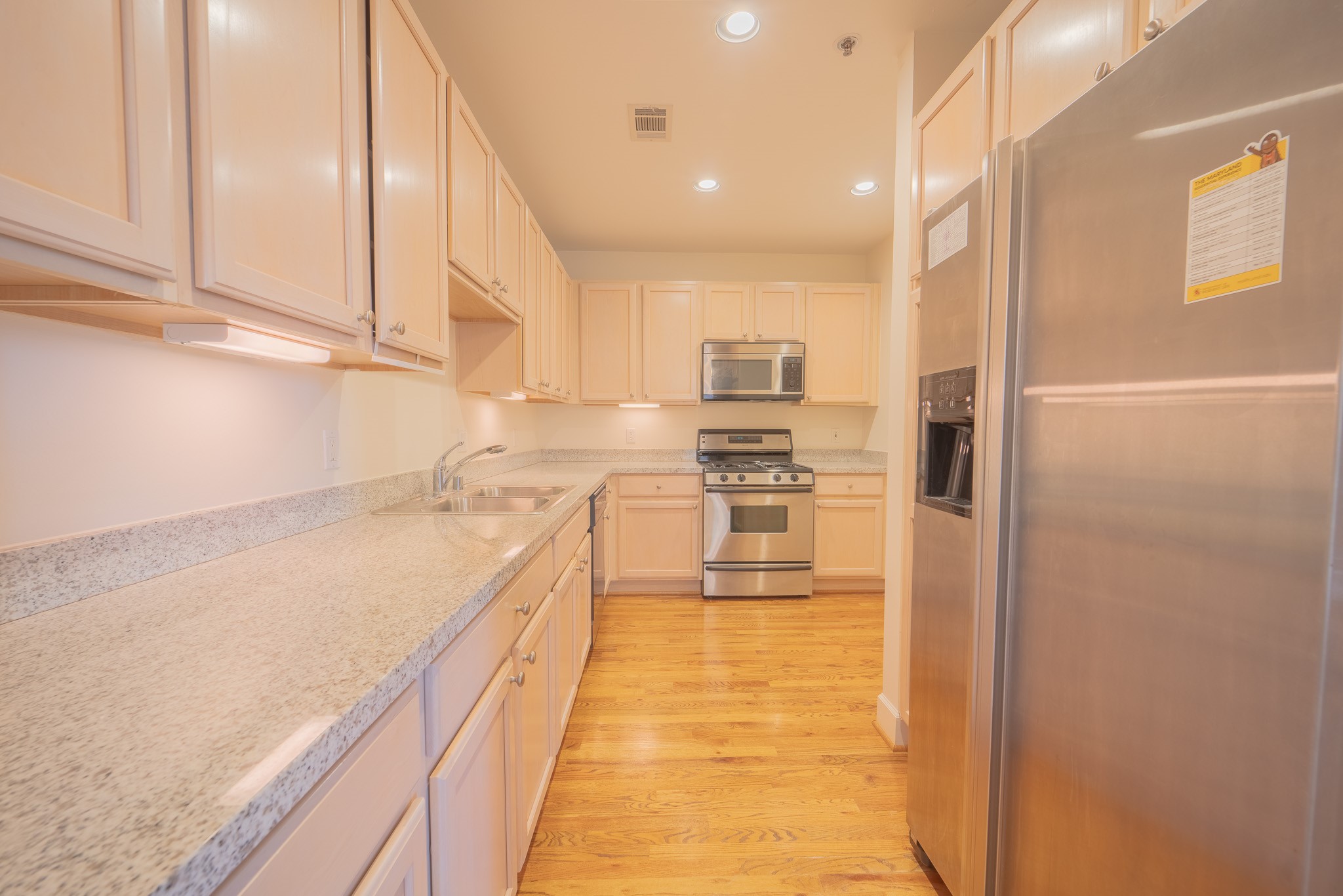 2520 Robinhood Street, Unit 505 Houston, TX 77005 - Photo 20 of 37 a kitchen with kitchen island a counter top space a stove and cabinets