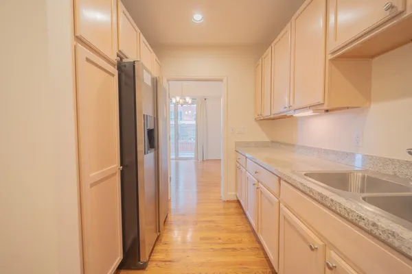 a kitchen with granite countertop white cabinets and white appliances