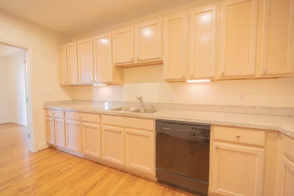 a kitchen with stainless steel appliances granite countertop a stove a microwave and a refrigerator