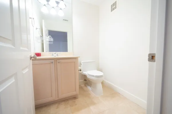 a bathroom with a sink vanity and a mirror