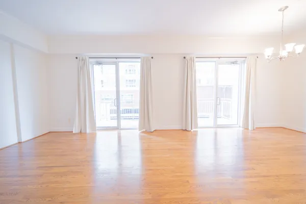 a view of an empty room and wooden floor