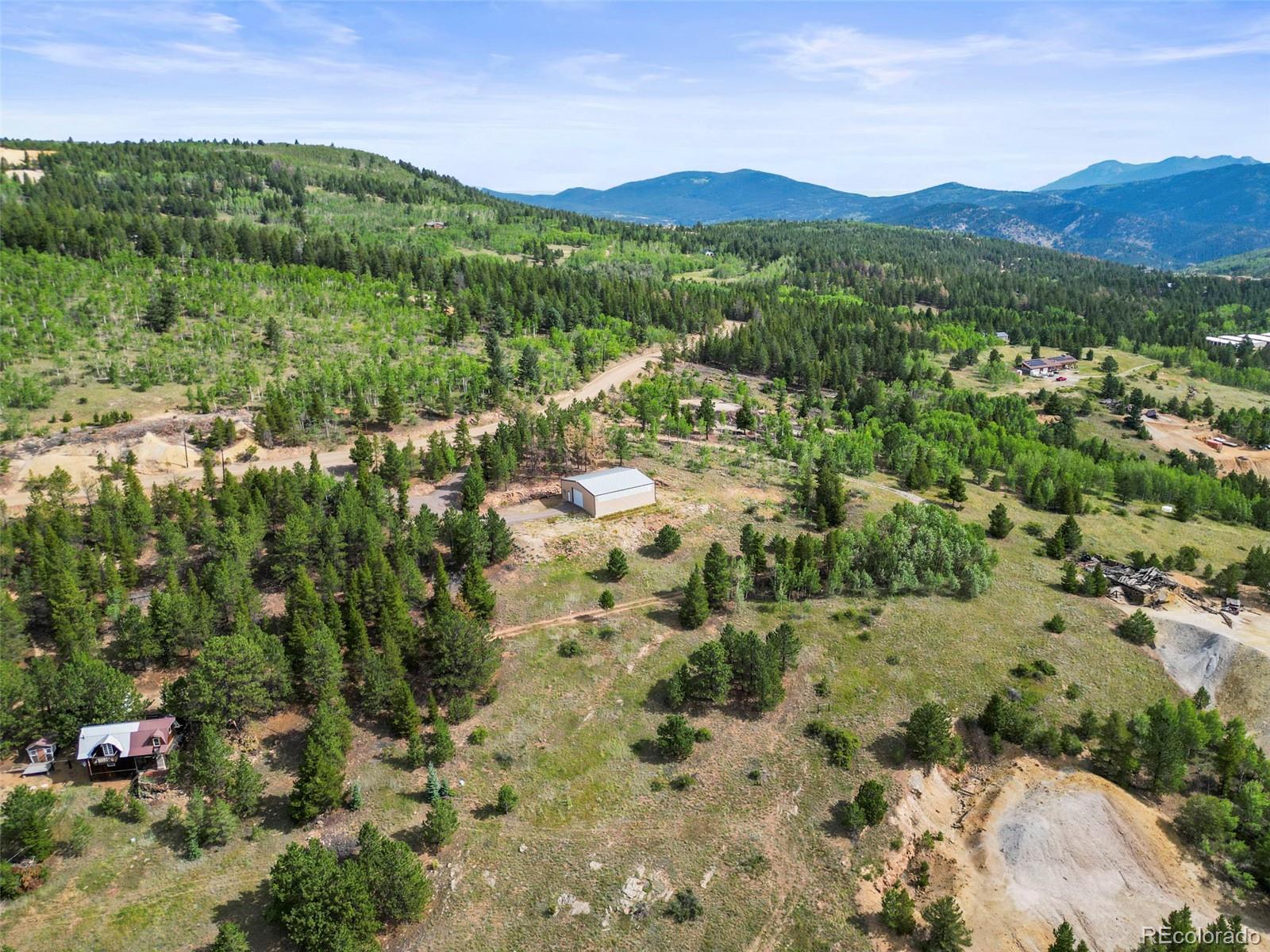 6660 Virginia Canyon Road Central City, CO 80427 - Photo 18 of 31 a view of a lush green hillside and houses