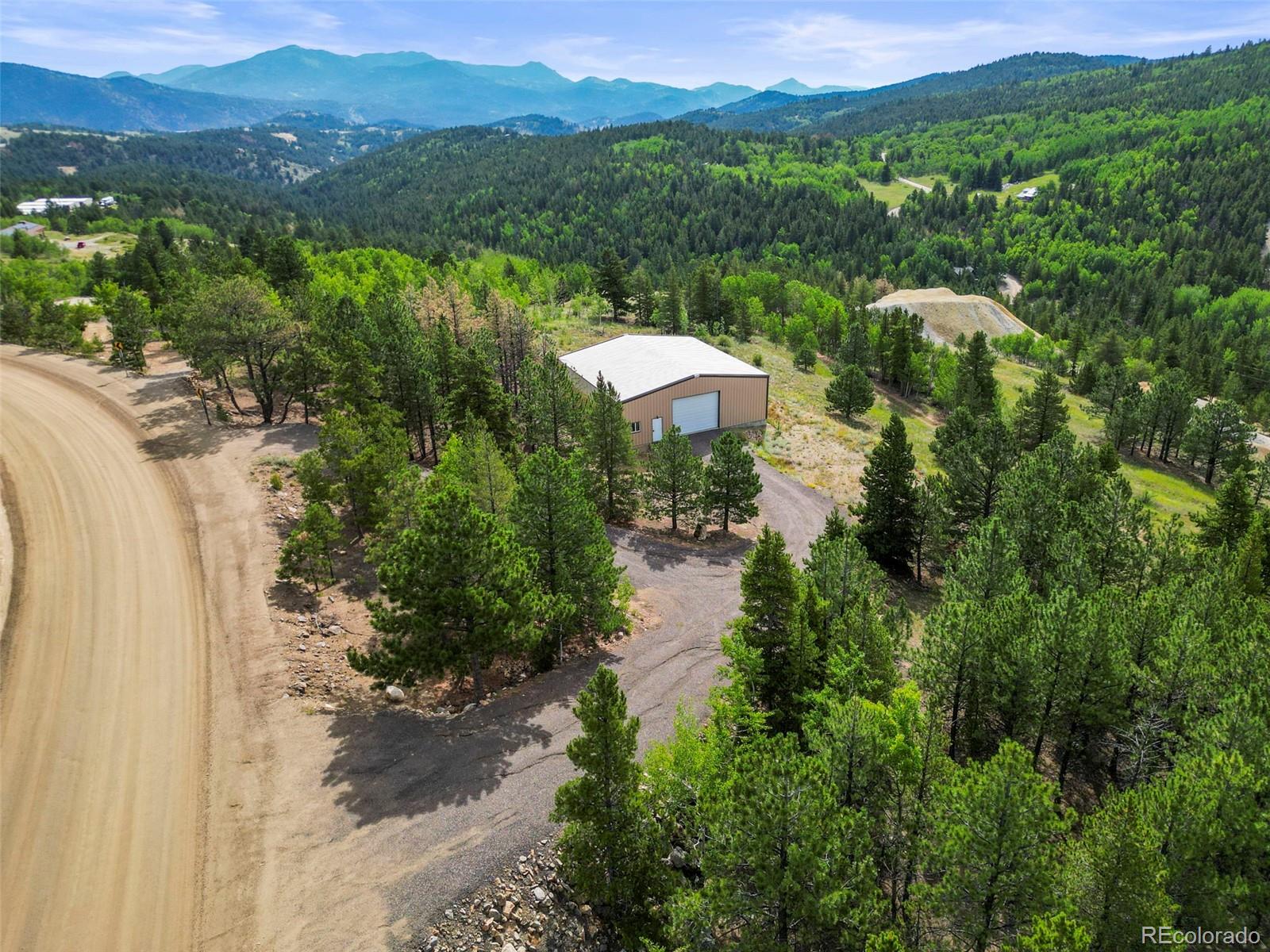 6660 Virginia Canyon Road Central City, CO 80427 - Photo 2 of 31 a view of a lake with a mountain in the background