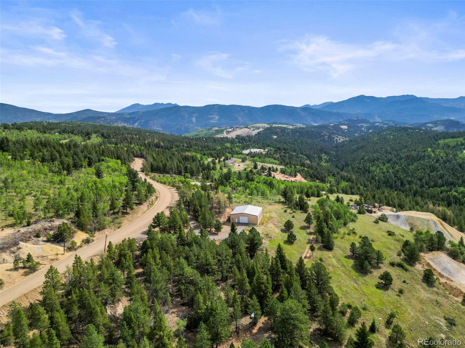 6660 Virginia Canyon Road Central City, CO 80427 - Photo 8 of 31 a view of a lush green field with mountains in the background