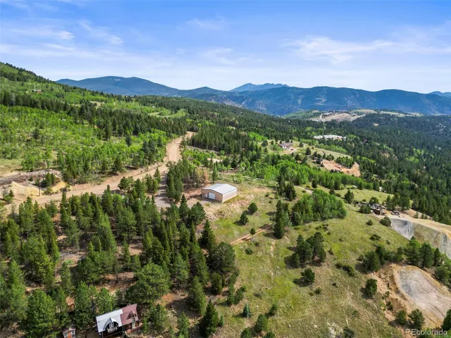 a view of a town with mountains in the background