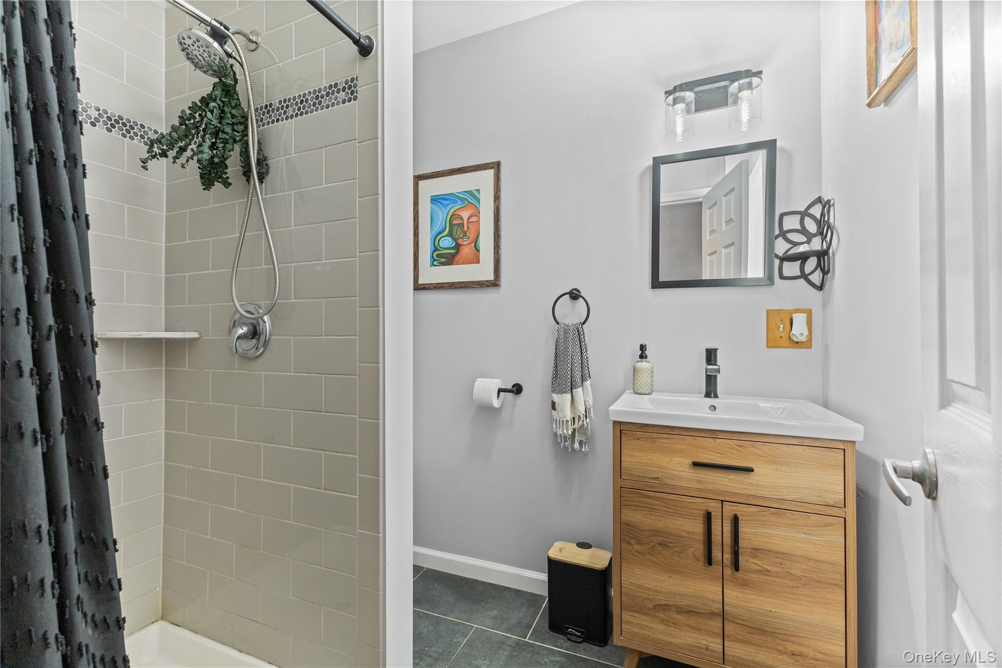 10 Helin Road Hopewell Junction, NY 12533 - Photo 20 of 35 Full bathroom featuring a stall shower, vanity, and dark tile patterned floors