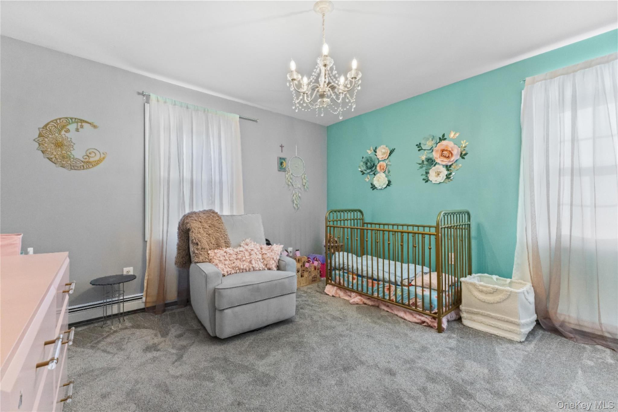 10 Helin Road Hopewell Junction, NY 12533 - Photo 23 of 35 Carpeted bedroom featuring a crib, baseboard heating, and a chandelier