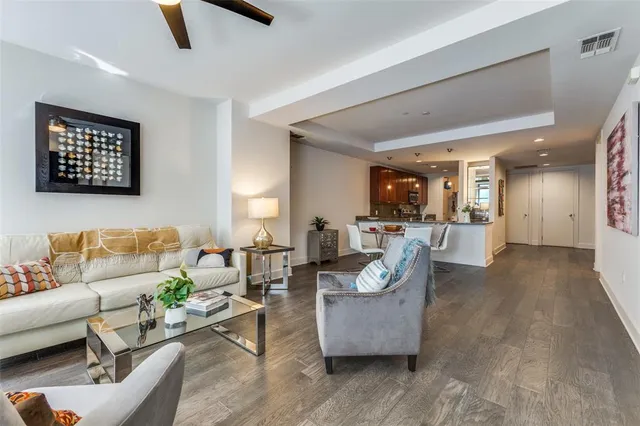 a living room with couches and a potted plant on table