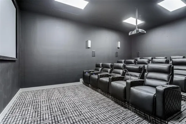 a room with furniture projector and screen