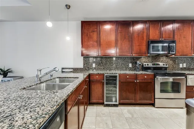 a kitchen with a sink stove and microwave
