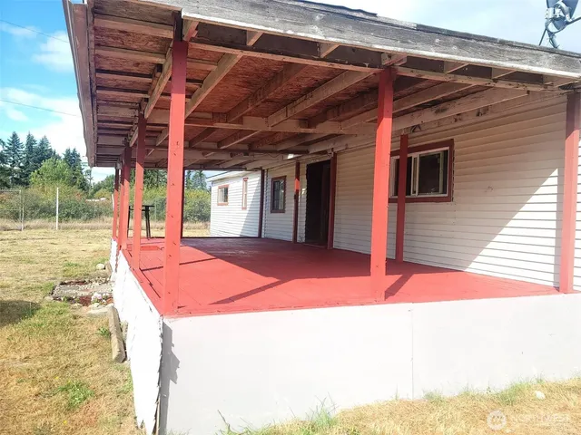 a backyard of a house with yard and staircase
