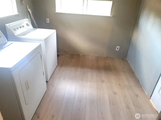 a view of washer and dryer with wooden floor