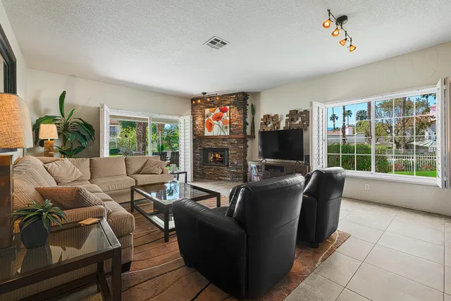 a living room with fireplace furniture and a flat screen tv