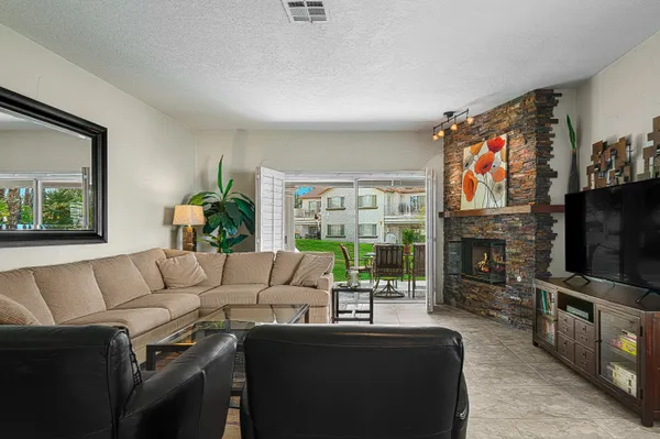a living room with fireplace furniture and a flat screen tv