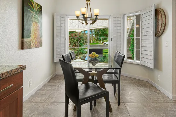 a dining room with furniture and window
