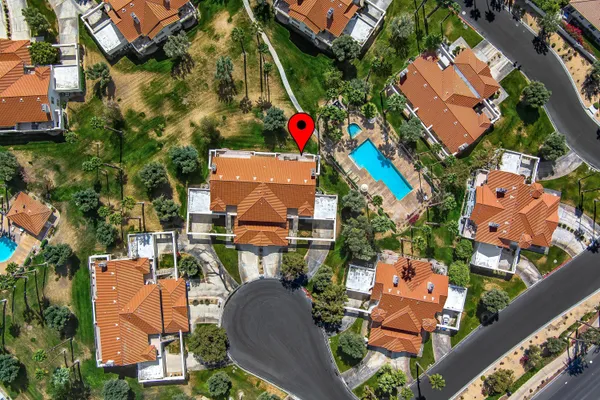 an aerial view of a houses with yard