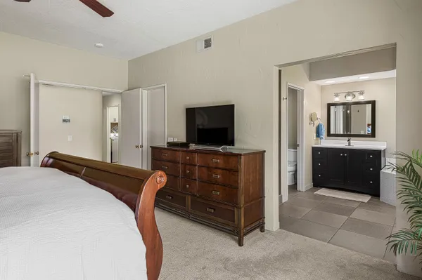 a bedroom with a bed and a flat screen tv