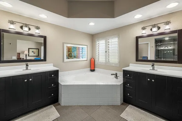 a spacious bathroom with a sink double vanity and a mirror
