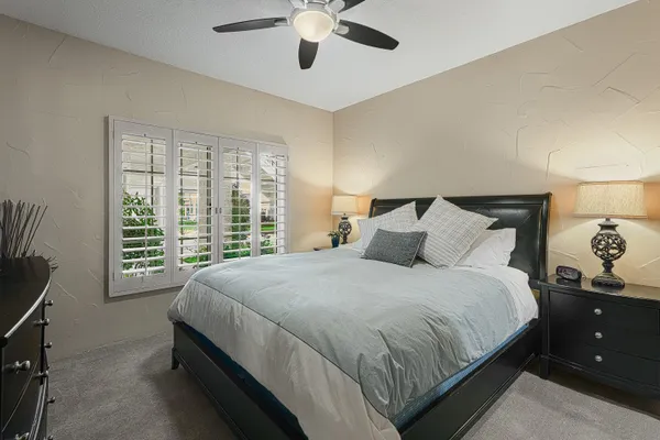 a large bed sitting in a bedroom next to a window