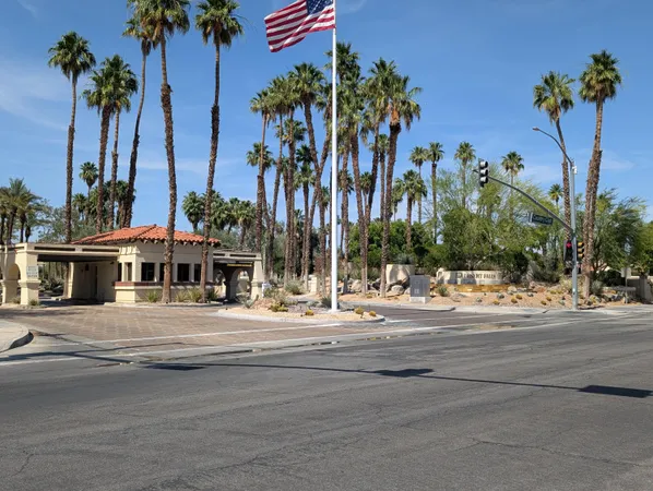 front view of a house with a palm tree