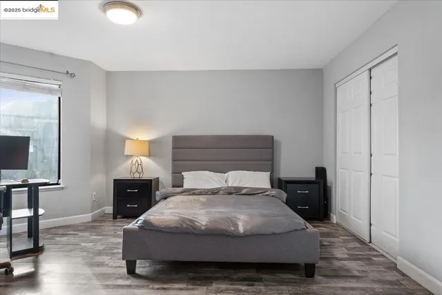 a bedroom with a bed and lamps on dresser