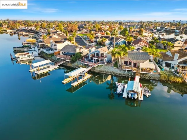an aerial view of residential houses with lake view