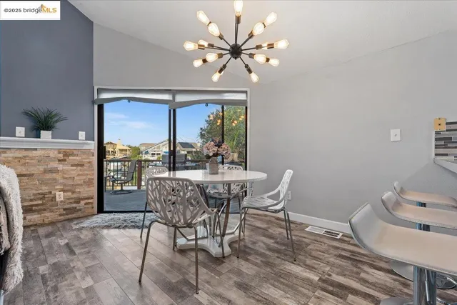 a living room with furniture a flat screen tv and kitchen view