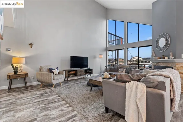 a kitchen with stainless steel appliances granite countertop a sink a stove a refrigerator cabinets and chairs