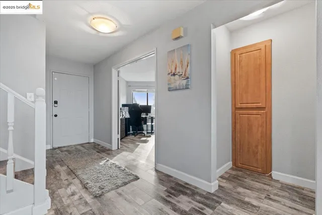 a living room with furniture a fireplace a rug and a large window