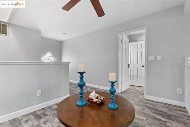 a bedroom with a bed a chair and a computer on a desk