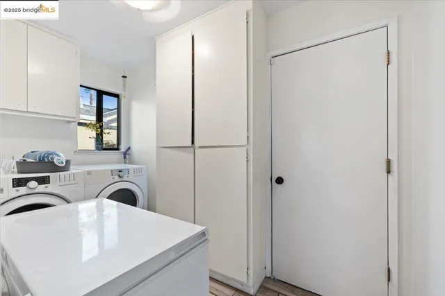 a view of washer and dryer with kitchen in the background