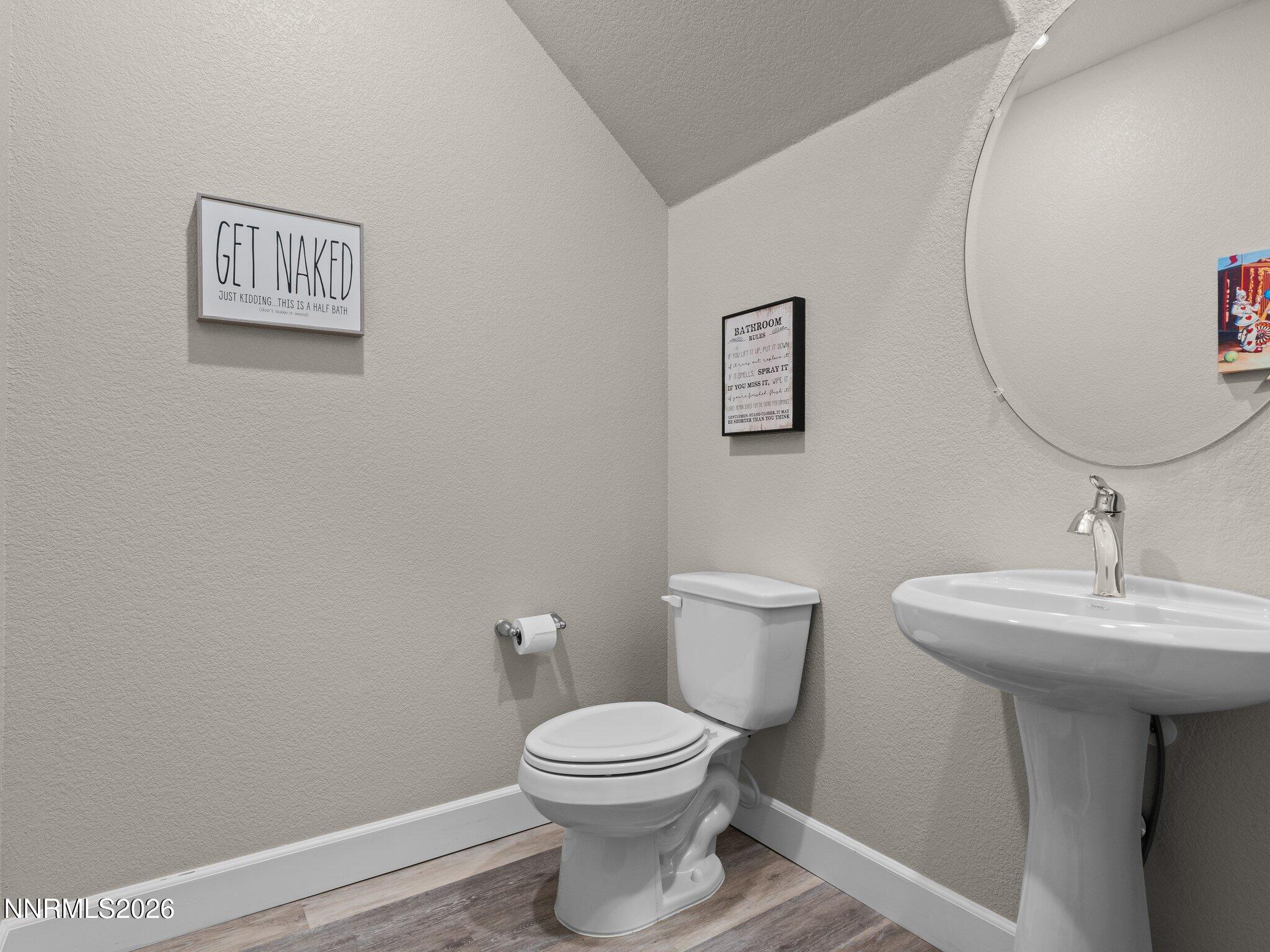 1914 Sea Horse Road, Unit C Reno, NV 89521 - Photo 13 of 28 a bathroom with a toilet a sink and mirror