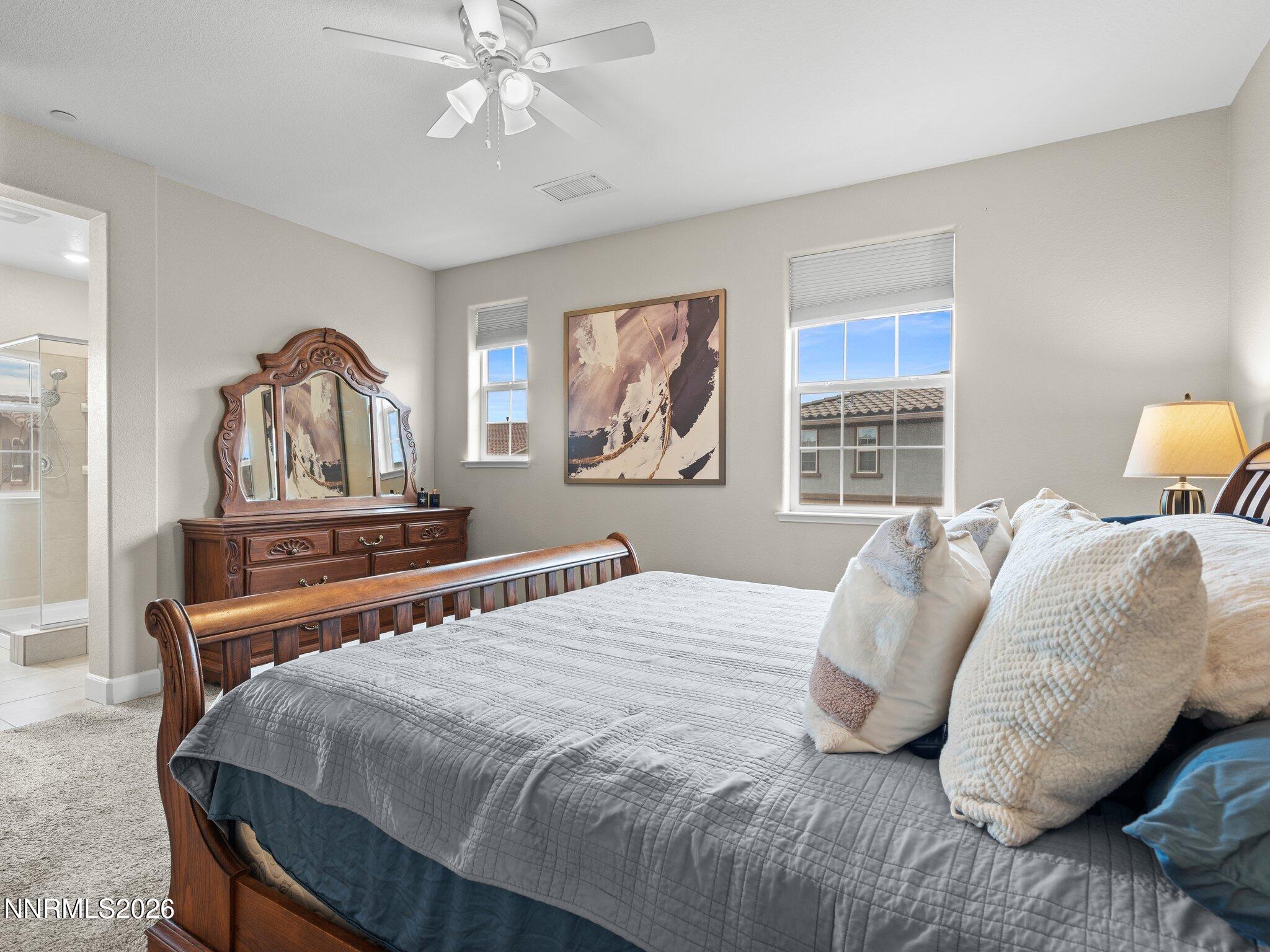 1914 Sea Horse Road, Unit C Reno, NV 89521 - Photo 16 of 28 a bedroom with a bed and dresser with mirror