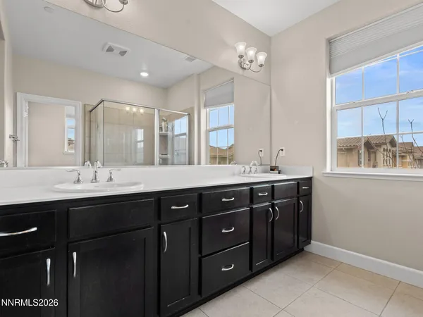 a bathroom with a sink vanity and mirror