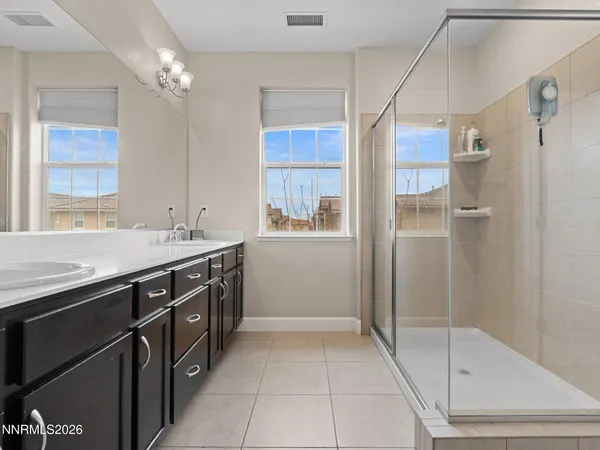 a spacious bathroom with a shower sink and mirror